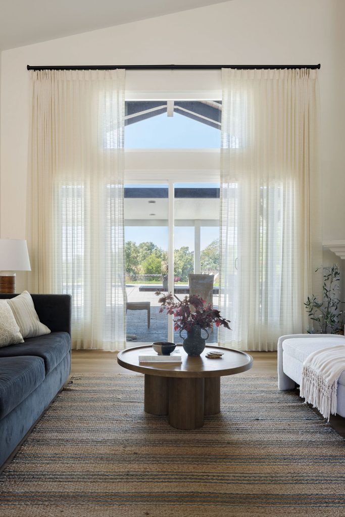 Sheer Monarch Pleat Drapery in a high-ceiling living room.