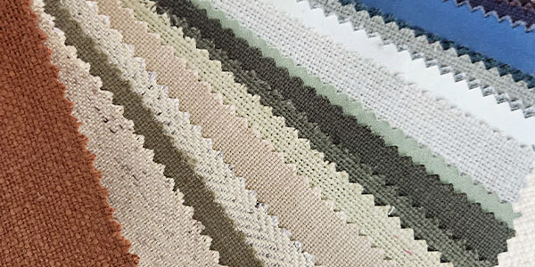 An array of colorful sustainable fabrics from the book Keep It Real featuring natural fibers from Carole Fabrics.