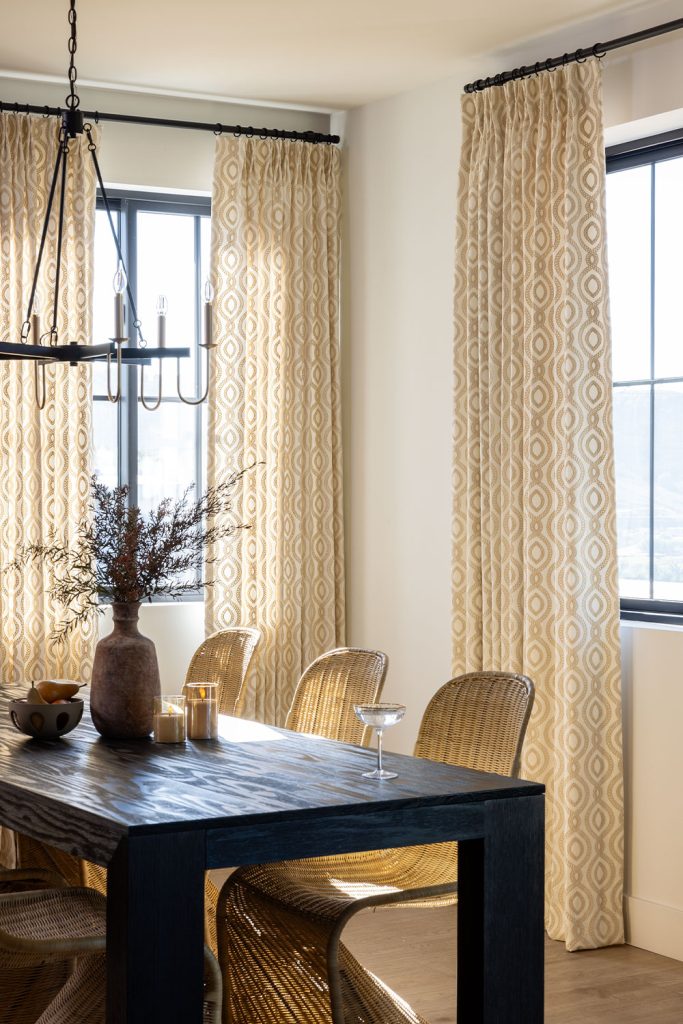 Monarch Pleat Drapery in neutral tones in an elegant rustic dining room.