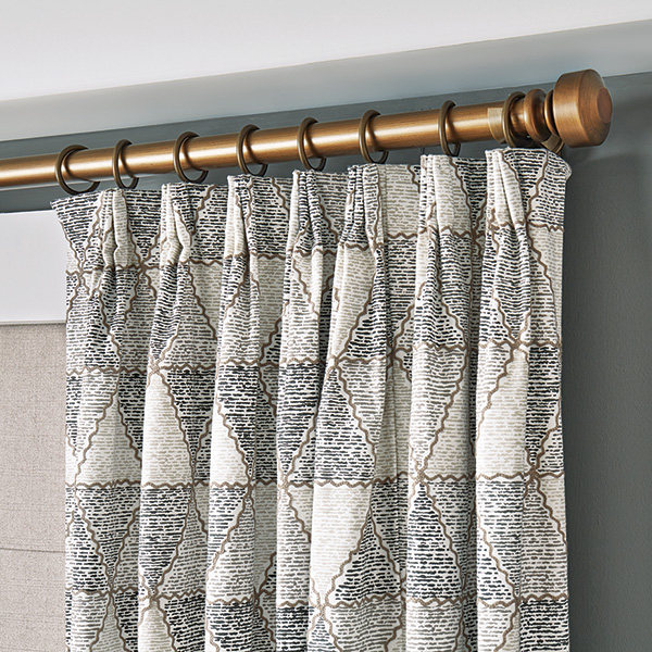 A close-up photo of a drapery header and hardware.