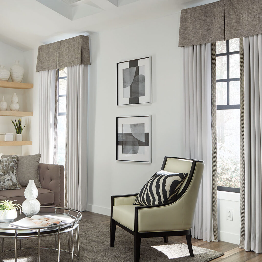 Beige textured Spencer Rod Mounted Valance top treatment over ivory drapery with beige trim in a modern living room.