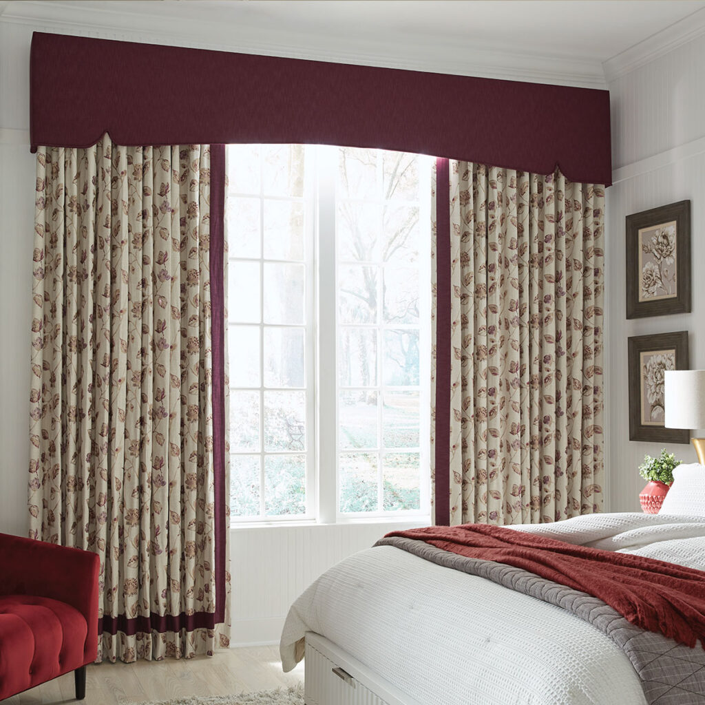 Deep red Savannah Cornice top treatment over red and cream leaf-patterned drapery in a bedroom.