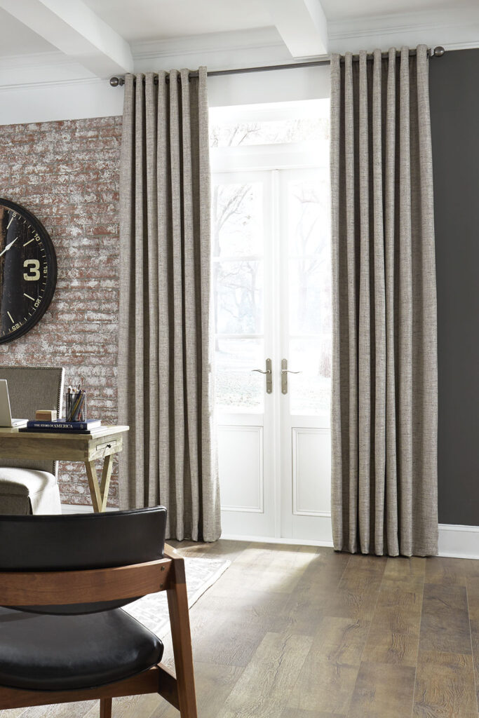 Grommet Heading EZ Panels in beige over white French doors in an office with a rustic brick wall.