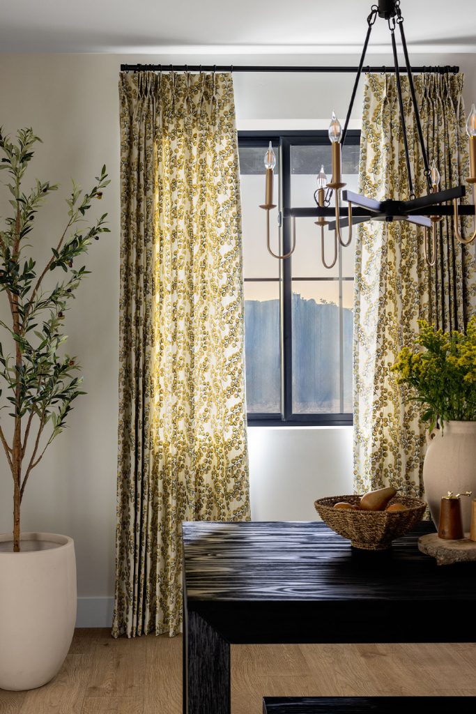 Two Finger Pinch Pleat EZ Panels over Two Finger Pinch Pleat Sheer Drapery in a dining room.